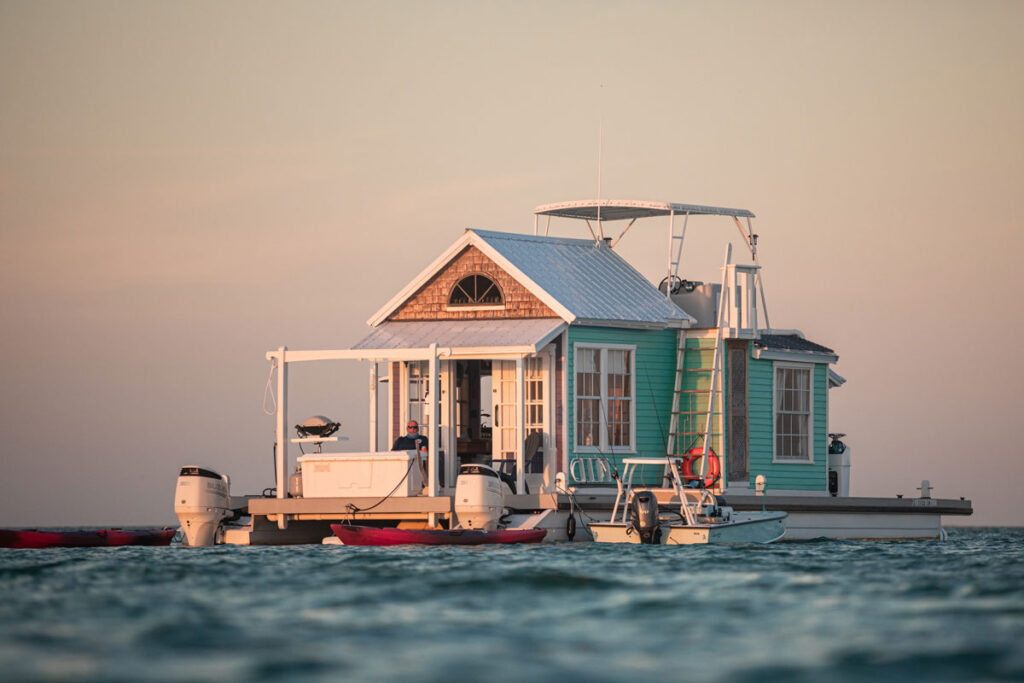 photo of a houseboat with a man chilling