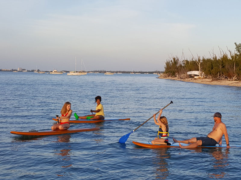 photo of a family on a paddle boarding tour